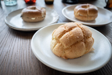Close up of Melon pan served on plate. Melon pan are Japanese sweet buns covered with a thin layer of cookie dough.