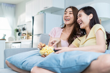 Obraz na płótnie Canvas Asian beautiful lesbian woman couple enjoy watch TV together in house. 
