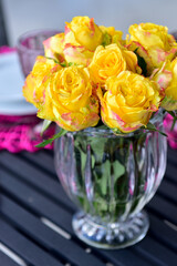 yellow roses in transparent glass vase, ornamental flowers