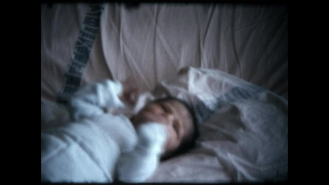 Newborn Baby 1972 - A newborn infant lies in bed. 