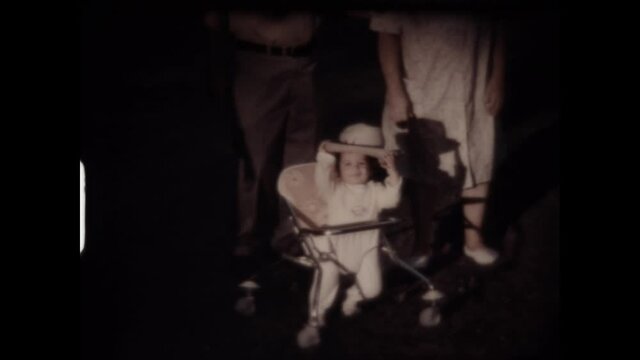 Toddler In A Cowboy Hat 1974 - A toddler wear a cowboy hat while sitting in his walker. 