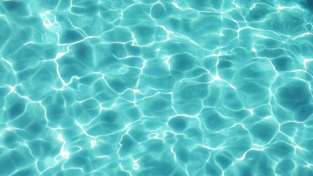 Clear pool water surface texture, swimming pool ripples and waves texture background. Top view sunlight reflection on sea surface. Summer sunshine water background. Transparent blue water in the pool