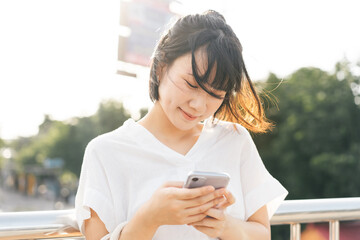 Young adult asian business woman using mobile phone find dating relationship via application.