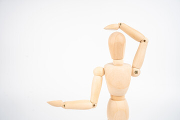 Wooden artist's dummy, confused by new idea (isolated on white background, copy space for your object or text)