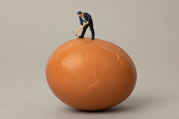 miniature worker is digging on egg 