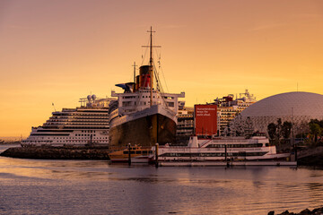 Queen Mary docked with a modern cruise ship behind it. © PixilRay
