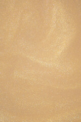 Golden glitter dust on dark background.