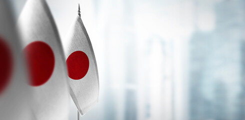 Small flags of Japan on a blurry background of the city