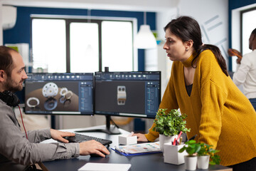 Teamwork engineer architects working on modern cad program developing construction metalic mechanism. Industrial designer studying prototype idea on pc showing digital software with gears concept