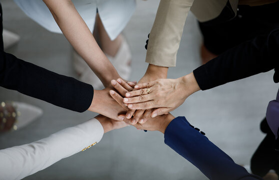 Top view close up shot of professional successful group of businessman businesswoman colleagues partnership team hands holding together for company strong trust teamwork unity achievement commitment