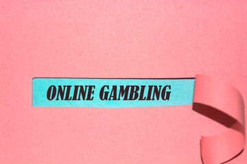 Online Gambling written under torn paper.