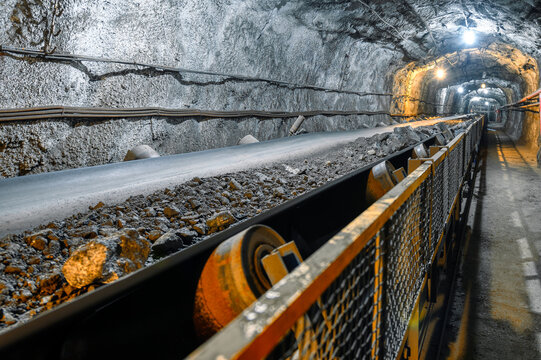 Belt conveyor in an underground tunnel. Transportation of ore to the surface