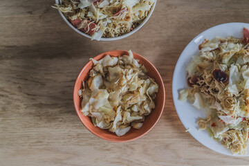 Cabbage fried with chicken meat and oyster sauce in a pan for cooking.