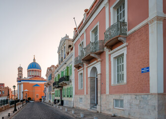 Old neoclassical mansions facing the Aegean Sea in the historic Vaporia neighbourhood, in Syros Island. The church of St Nicholas is in the background.