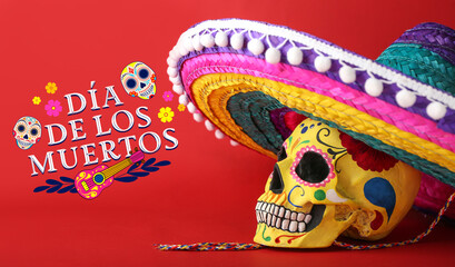 Painted human skull for Mexico's Day of the Dead (El Dia de Muertos) and sombrero hat on color...