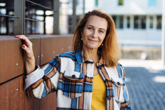 Attractive trendy middle-aged woman in a checked jacket