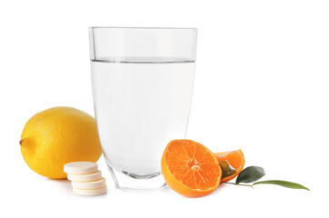Glass of water, pills and citrus fruits on white background