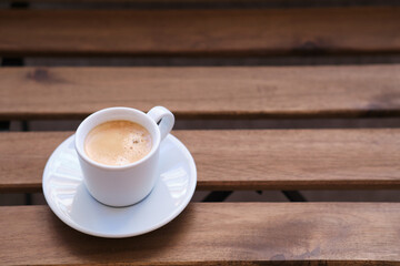 Cup of coffee on wooden table