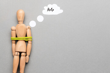 Mannequin with tied around rope on grey background. Concept of hostage