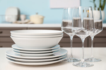 Set of clean dishes on table in kitchen