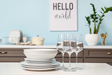 Set of clean dishes on table in kitchen