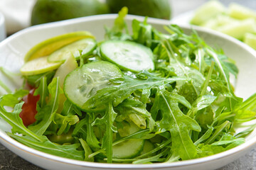 Plate with healthy salad on grey background