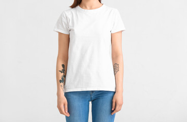 Young woman in modern t-shirt on white background