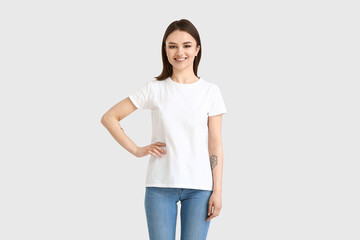 Obraz premium Young woman in modern t-shirt on white background