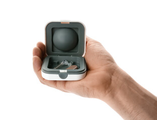 Man holding box with hearing aid on white background