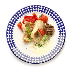 Plate with tasty baked cod fillet, vegetables and sauce on white background