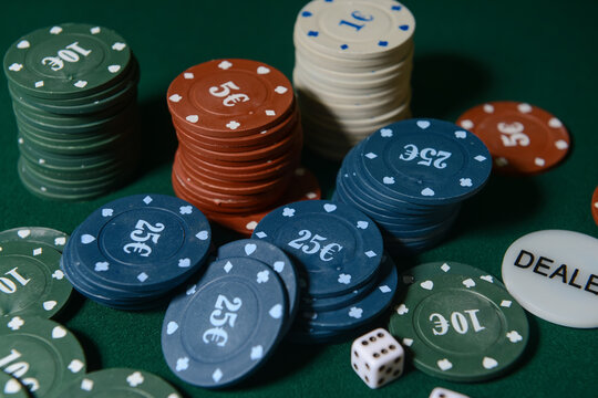 Poker chips and dices on dark background
