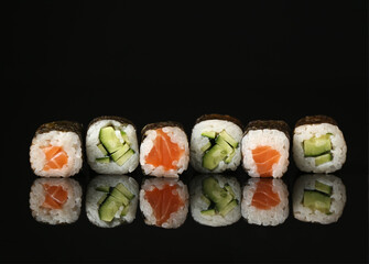 Set of different maki rolls on dark background