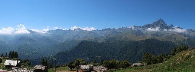 the Monviso mountain, shrouded in morning fog, on a hot summer day in Crissolo