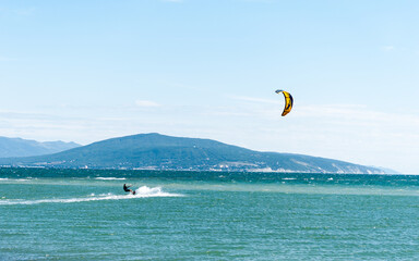 seascape with a kite. kite on the sea waves. a man rides a kite. sports and adrenaline