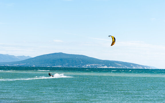 seascape with a kite. kite on the sea waves. a man rides a kite. sports and adrenaline