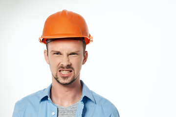 male builder orange helmet engineer safety light background