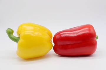 red and yellow peppers on white background