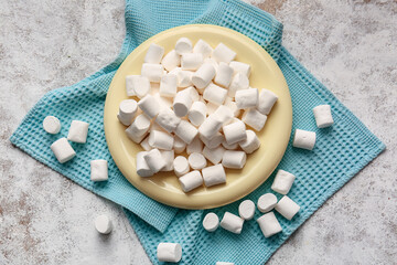 Fototapeta na wymiar Plate with tasty marshmallows on light background