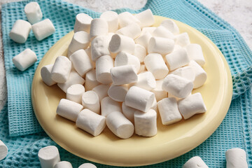 Fototapeta na wymiar Plate with tasty marshmallows on table