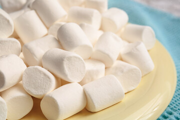 Plate with tasty marshmallows on table, closeup