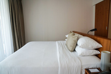 close up minimal double bed with white mattress in luxury hotel bedroom for honeymoon in holidays