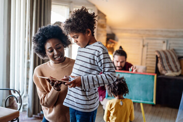Happy family using tablet for playing game watching movies, relaxing at home for lifestyle concept