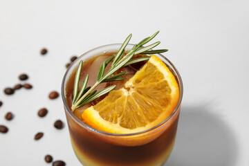 Glass of tasty coffee with orange juice on light background, closeup