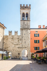 Fototapeta na wymiar View at the Gate of San Michele in the streets of Riva del Garda in Italy