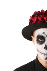 Young man with painted skull on his face against white background. Celebration of Mexico's Day of the Dead (El Dia de Muertos)