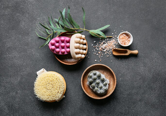Massage soap bars, brush and sea salt on dark background