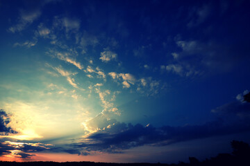 Naklejka na ściany i meble Romantic sky on summer sunset. Beautiful clouds.