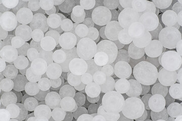 Sodium Hydroxide beads or lye - closeup detail to white granules, image width 19mm