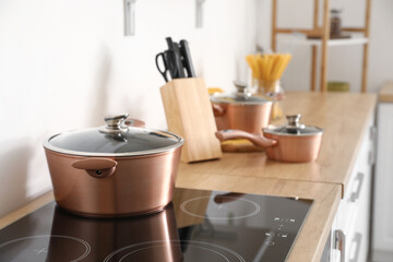 Big copper cooking pot on stove in kitchen