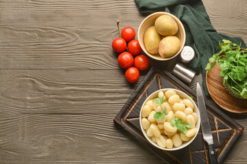 Composition with tasty gnocchi on color wooden background